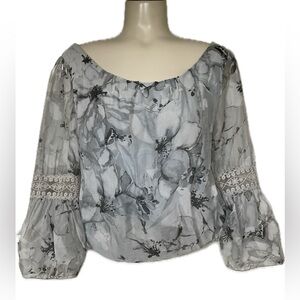 Delicate lined over the head blouse with lace sleeves and bubble hem.